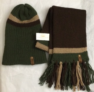 - Unisex Accessories - Material: 100% Acrylic Yarn, Custom Riveted Faux Leather Tags  Construction: Double Layered Knit Scarf and Beanie    Color(s): Forrest Green, Barley and Chocolate Brown  Size: OS Stretchable 