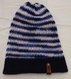Material: 100% Acrylic Yarn, Custom Riveted Faux Leather Tags  Construction: Double Layered Knit Scarf and Beanie    Color(s): Blue and Purple Mixed Yarn  Size: OS Stretchable  